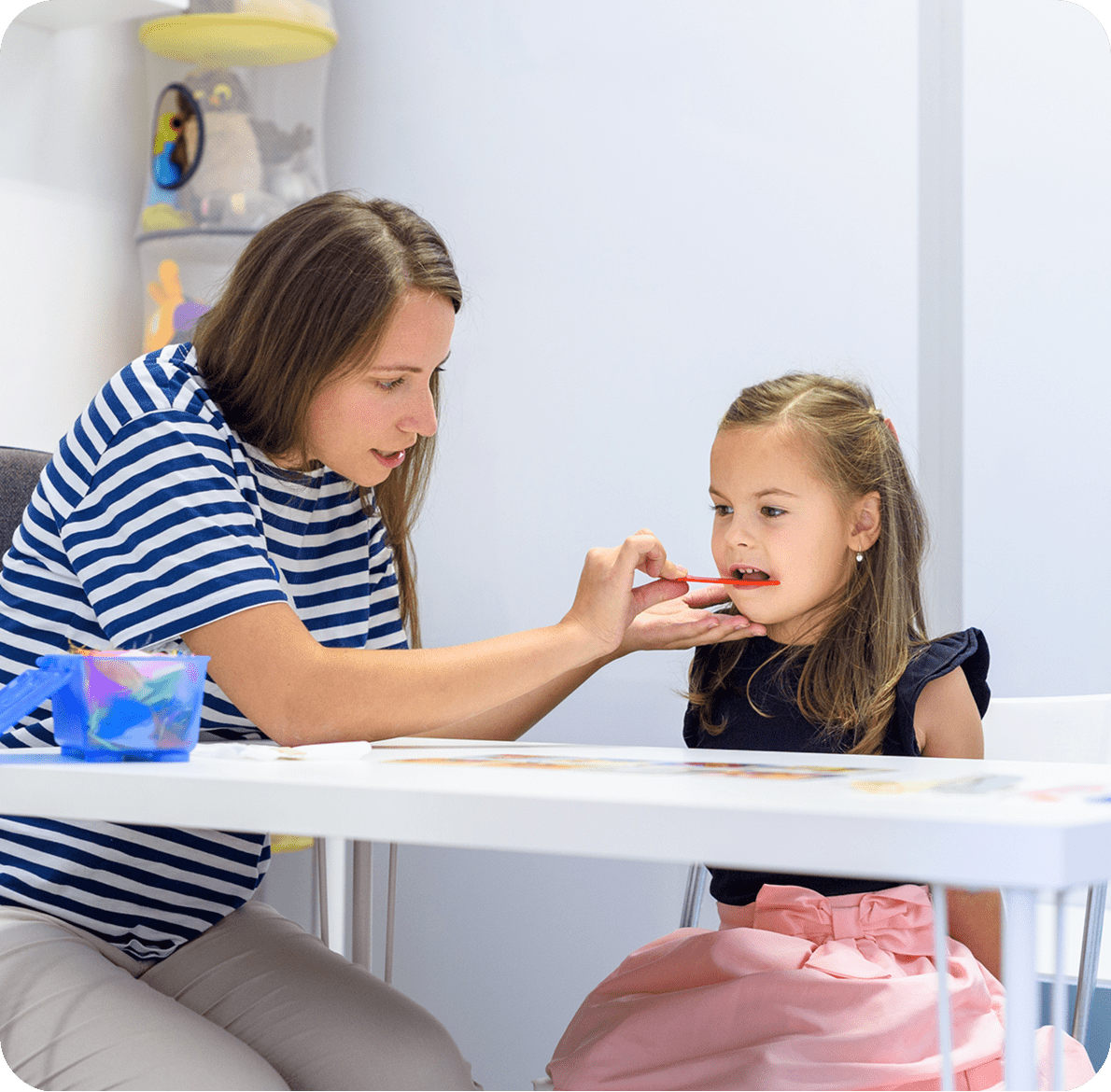 Teacher helping child with speech therapy