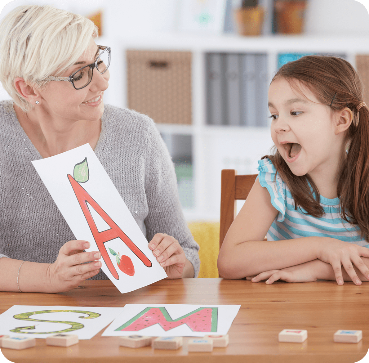 Alphabet lesson with teacher and student