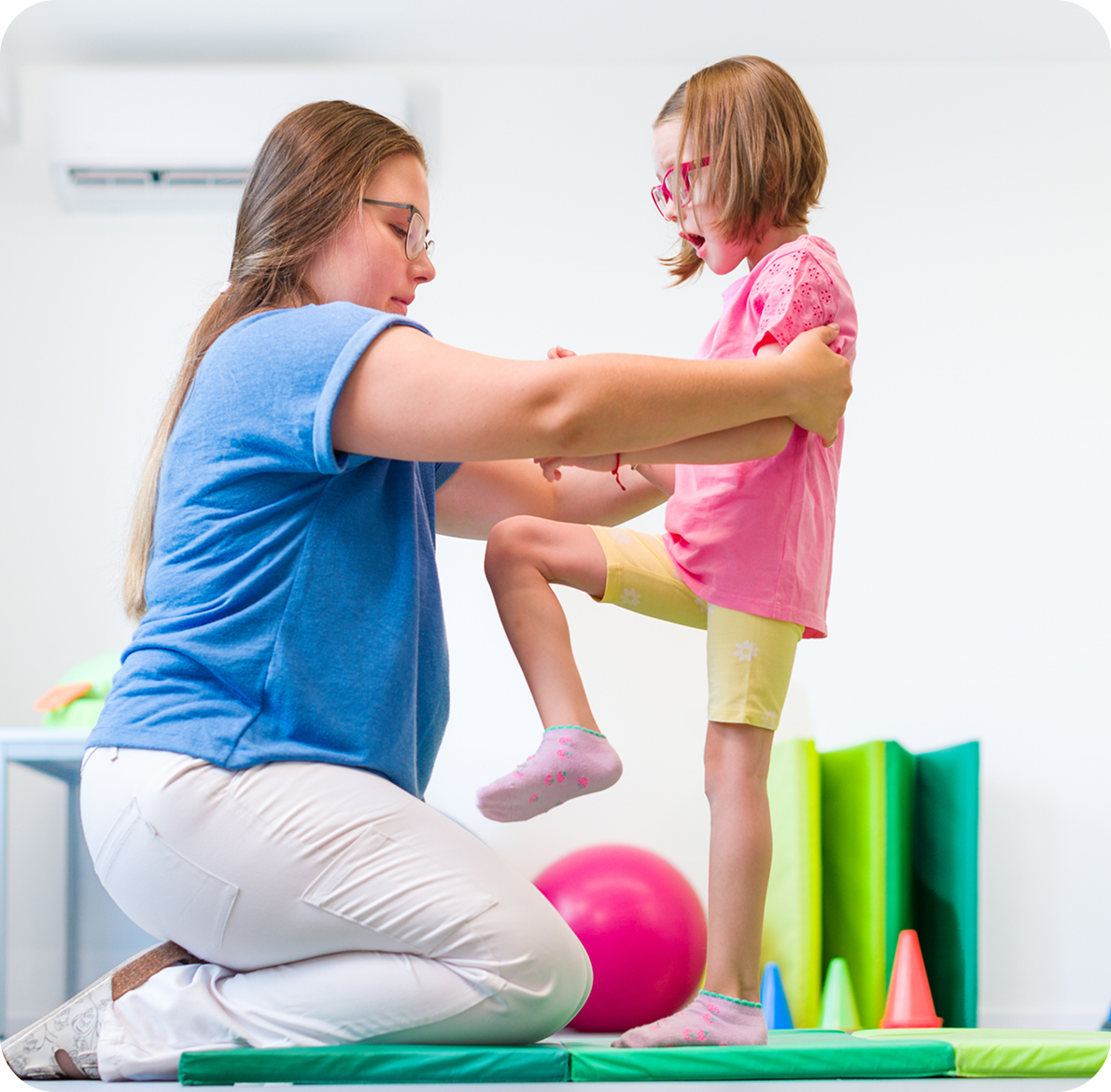 Child practicing balance with therapist's help