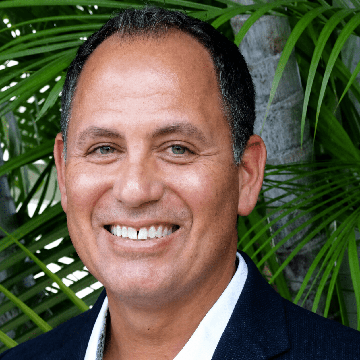 Man in suit with palm leaves